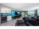 Modern living room boasts a chic wet bar, bright blue accent wall, and comfortable, contemporary furnishings at 1460 Gulf Blvd # 506, Clearwater Beach, FL 33767