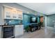 Living room features a bar area with a wine cooler and modern entertainment center at 1460 Gulf Blvd # 506, Clearwater Beach, FL 33767