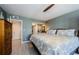 Comfortable bedroom features tiled floors, ensuite bath, and dresser at 1460 Gulf Blvd # 506, Clearwater Beach, FL 33767