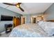 Relax in this peaceful main bedroom featuring wood floors, fan, and ensuite bath at 1460 Gulf Blvd # 506, Clearwater Beach, FL 33767