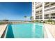 Beautiful pool next to beach with lounge chairs and view of ocean and beach at 1460 Gulf Blvd # 506, Clearwater Beach, FL 33767