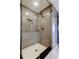 Beautifully tiled walk-in shower with mosaic accents, built-in shelving, and a glass door at 1460 Gulf Blvd # 506, Clearwater Beach, FL 33767