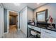 Bright vanity area with storage, large mirror, and a view to the main bath at 1460 Gulf Blvd # 506, Clearwater Beach, FL 33767
