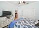 Bedroom featuring a blue and white patterned bed and a view towards the kitchen at 15728 Aurora Lake Cir, Wimauma, FL 33598