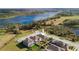 An aerial shot of the home with backyard, nestled among lush greenery and serene water views at 1593 Secluded Garden Ln, Lutz, FL 33558