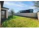 Expansive backyard featuring well-maintained lawn and a privacy fence at 1593 Secluded Garden Ln, Lutz, FL 33558