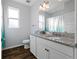 Stylish bathroom featuring granite counters, modern fixtures, and wood-look tile flooring at 1593 Secluded Garden Ln, Lutz, FL 33558