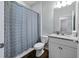Bathroom featuring patterned shower curtain, neutral paint, and tiled flooring at 1593 Secluded Garden Ln, Lutz, FL 33558