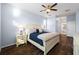 Comfortable bedroom with wood-look floors, an ensuite bathroom, and great natural light at 1593 Secluded Garden Ln, Lutz, FL 33558