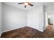 Bedroom featuring a ceiling fan, closet, wood-look tile flooring, and neutral walls at 1593 Secluded Garden Ln, Lutz, FL 33558