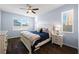 Bright bedroom with wood-look floors, large window and a stylish ceiling fan at 1593 Secluded Garden Ln, Lutz, FL 33558