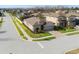 Beautifully landscaped corner lot home with a brick driveway and neutral-tone exterior at 1593 Secluded Garden Ln, Lutz, FL 33558