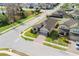 Aerial view of the home showcasing the well-manicured lawn and brick driveway on a corner lot at 1593 Secluded Garden Ln, Lutz, FL 33558