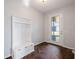 Inviting foyer with a convenient storage bench and stylish herringbone-patterned floors at 1593 Secluded Garden Ln, Lutz, FL 33558