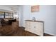 Hallway with wood flooring, accent cabinet and views of the living room and outdoor patio at 1593 Secluded Garden Ln, Lutz, FL 33558
