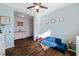 Inviting playroom with blue accent wall, ceiling fan and wood-look tile flooring at 1593 Secluded Garden Ln, Lutz, FL 33558
