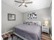 Modern bedroom showcasing a gray bed, unique rug, hardwood floors, and stylish accents at 1708 Country Trails Dr, Safety Harbor, FL 34695