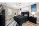 Luxurious bedroom with a tufted headboard, wood floors, and elegant decor at 1708 Country Trails Dr, Safety Harbor, FL 34695