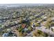 Expansive aerial view of waterfront property with boat dockage and mature landscaping in residential neighborhood near the ocean at 1772 Indian Rocks S Rd, Largo, FL 33774