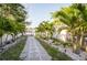 Serene backyard pathway lined with palm trees, leading to waterfront at 1772 Indian Rocks S Rd, Largo, FL 33774