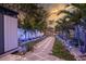 Tranquil backyard with a stone walkway and tropical landscaping leading to the waterfront at 1772 Indian Rocks S Rd, Largo, FL 33774