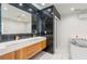 Modern bathroom with double vanity, marble backsplash, and glass shower at 1772 Indian Rocks S Rd, Largo, FL 33774