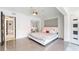 This spacious bedroom features tile floors, a mirrored closet, and a modern ceiling fan at 1772 Indian Rocks S Rd, Largo, FL 33774