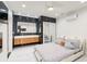 Modern bedroom with sleek, tiled floors, accent wall and ensuite bathroom at 1772 Indian Rocks S Rd, Largo, FL 33774