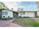 Well-maintained single-story home with a manicured front lawn and attached garage at 1772 Indian Rocks S Rd, Largo, FL 33774