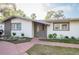Charming single-story home featuring brick accents, well-maintained landscaping, and a welcoming walkway to the front door at 1772 Indian Rocks S Rd, Largo, FL 33774