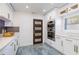 Modern kitchen with stainless steel appliances, custom cabinetry, white countertops, and luxurious flooring at 1772 Indian Rocks S Rd, Largo, FL 33774