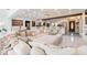 Bright and airy living room showcasing an oversized white sectional, leading into a stylishly designed kitchen and entry at 1772 Indian Rocks S Rd, Largo, FL 33774