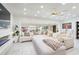 Bright living room with large sectional couch, fireplace, and big windows at 1772 Indian Rocks S Rd, Largo, FL 33774