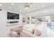 Spacious living room with white sofa, modern fireplace, and large TV at 1772 Indian Rocks S Rd, Largo, FL 33774