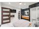 Modern main bedroom featuring an accent wall with black tile, floating vanity, and luxurious finishes at 1772 Indian Rocks S Rd, Largo, FL 33774