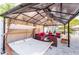 Cozy outdoor living space with relaxing seating options and shade under a stylish gazebo at 1772 Indian Rocks S Rd, Largo, FL 33774