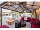 Outdoor lounge area features stylish seating under the gazebo and overlooking a beautiful pool at 1772 Indian Rocks S Rd, Largo, FL 33774