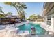 Backyard oasis featuring a luxurious pool with water features and inviting cabana seating areas at 1772 Indian Rocks S Rd, Largo, FL 33774