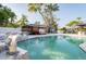 This beautiful pool features an artistic waterfall and multiple outdoor gathering spaces at 1772 Indian Rocks S Rd, Largo, FL 33774