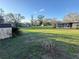 Expansive backyard featuring a shed, mature trees, and a screened in back porch at 18401 Hamilton Rd, Dade City, FL 33523
