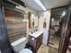 Rustic bathroom featuring wood accents, tiled walls, and a wood vanity with a sink at 18401 Hamilton Rd, Dade City, FL 33523