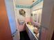 Nautical themed bathroom has a large vanity with a sink and plenty of storage for toiletries at 18401 Hamilton Rd, Dade City, FL 33523
