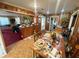 Charming dining area with wood-paneled walls, a view of the living room, and a traditional dining set at 18401 Hamilton Rd, Dade City, FL 33523