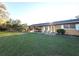 Inviting home exterior with a covered carport and well-maintained lawn, creating a welcoming curb appeal at 18401 Hamilton Rd, Dade City, FL 33523