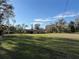 Spacious front yard with mature trees, and charming single-story home at 18401 Hamilton Rd, Dade City, FL 33523