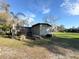 Charming home featuring a spacious backyard surrounded by beautiful greenery, offering a serene and private oasis at 18401 Hamilton Rd, Dade City, FL 33523