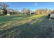 Wide shot of the home's exterior and sheds surrounded by a well-maintained lawn at 18401 Hamilton Rd, Dade City, FL 33523