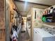 Hallway decorated with rustic wood finishes and a washer and dryer at 18401 Hamilton Rd, Dade City, FL 33523
