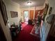 Hallway with red carpet and wallpaper; vintage style details at 18401 Hamilton Rd, Dade City, FL 33523