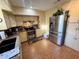 Functional kitchen features tile flooring, stainless steel appliances, and ample cabinet space for storage at 18401 Hamilton Rd, Dade City, FL 33523